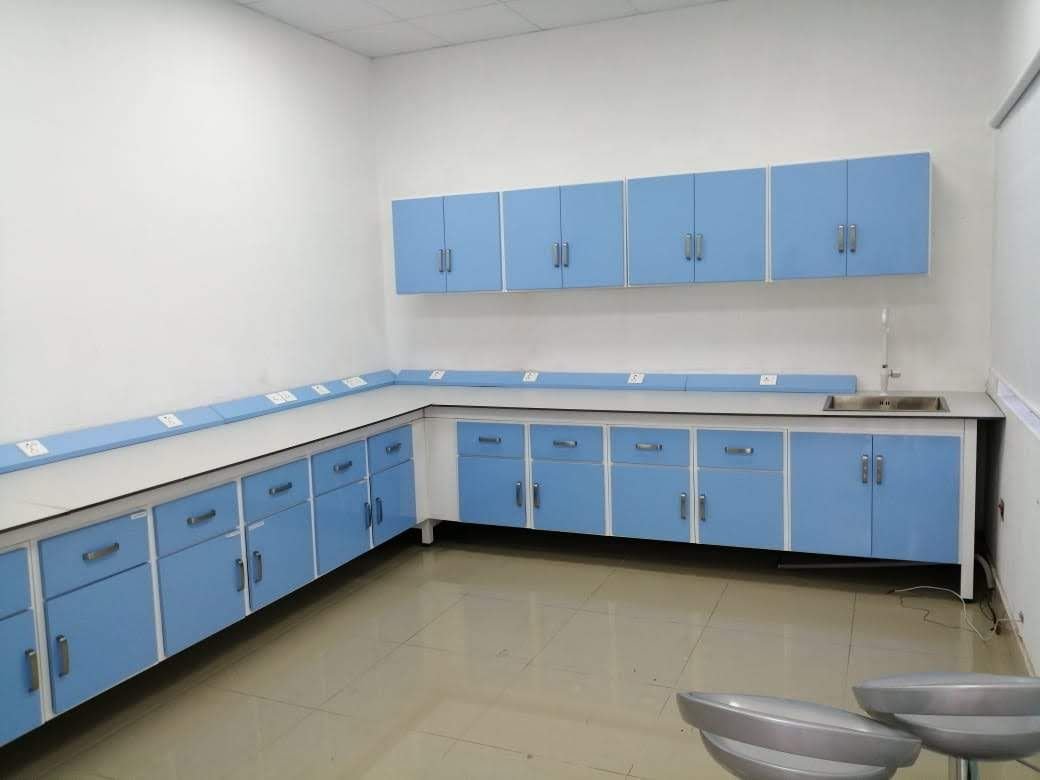 Installed L-shaped laboratory bench with wall cabinets and sink
